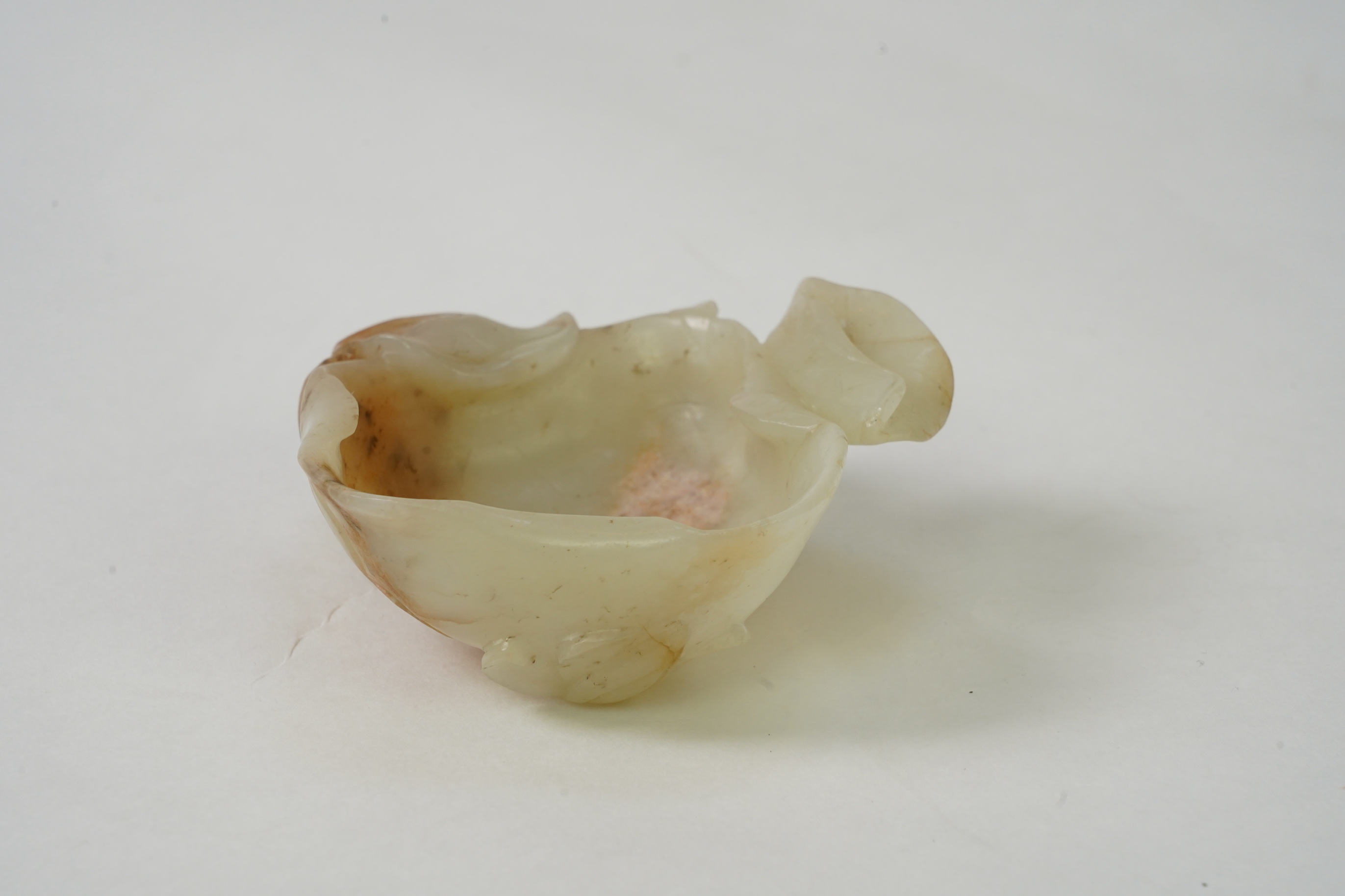 A Chinese pale celadon and russet jade brushwasher, Ming dynasty, 16th/17th century